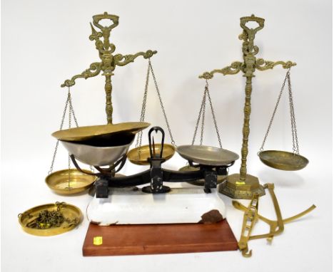 Five examples of vintage scales to include three brass beam scales with brass pans and decorative bodies, a set of Avery whit