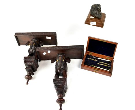 A vintage mahogany case part geometry set, a bronzed head of an Inca in ceremonial dress to mahogany stepped plinth, height 9