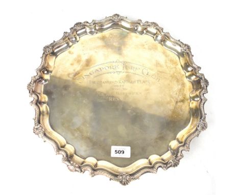 A large hallmarked silver winner's tray with shaped raised gallery sides embellished with applied shells and garlands of flow