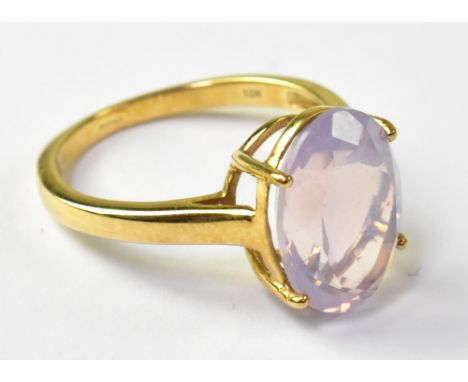 A 9ct yellow gold ladies' dress ring with oval facet cut rose quartz stone, size R, approx 4g.