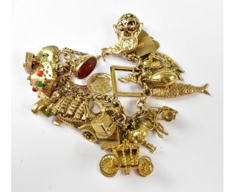 A 9ct gold charm bracelet with approximately twenty-five gold charms, to include seal fobs, harp, enamelled Chinese lantern, 