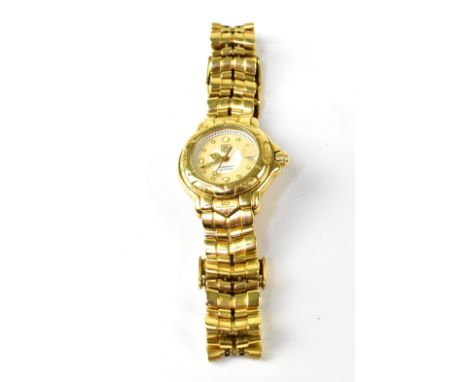 TAG HEUER; a 6000 model 18ct yellow gold ladies' watch, the white and beige tone circular dial set with raised zero time incr