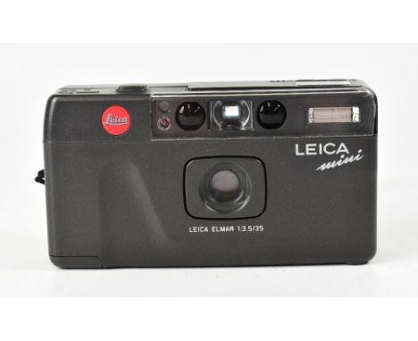 LEICA; a mini 35mm point and shoot film camera with fixed Elmar 35mm F3.5 lens and case. CONDITION REPORT The camera body is 