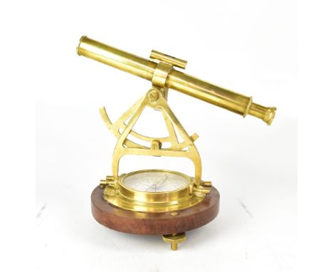 A brass ship's sextant on circular mahogany base, to three brass supports.