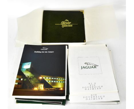 Sixteen Jaguar car brochures to include Annual Reports dating from the 1980s, Jaguar accessories brochure, a boxed leather-bo