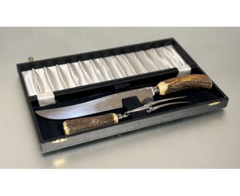 A cased sheffield stainless steel stags horn carving knife and fork knife L x 37cm shows no to little signs of use&nbsp;
