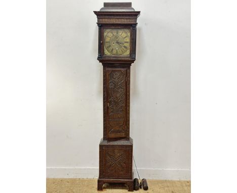 A late 19thc/early 20thc. oak longcase clock, with carved top, with brass dial, by George Phillips, London, with date apertur