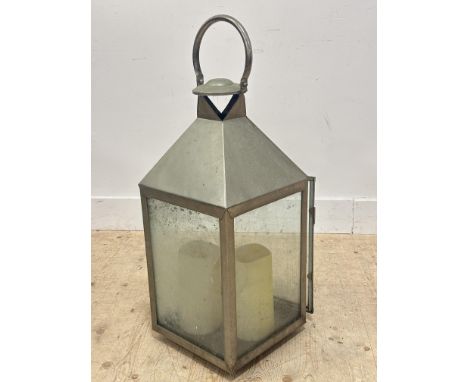 A large New England style chrome plated floor standing lantern with loop handle to top, with two battery powered candles (h.8