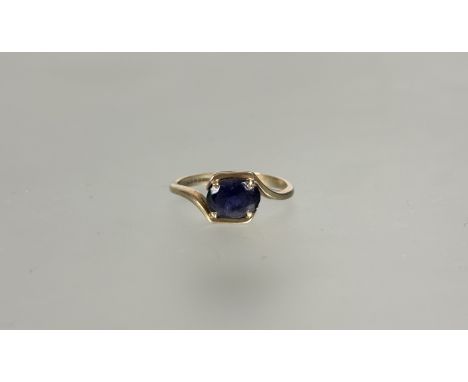 A 9ct gold oval sapphire solitaire ring mounted in scrolling crossover claw set mount approximately .75ct I/J 1.67g&nbsp;