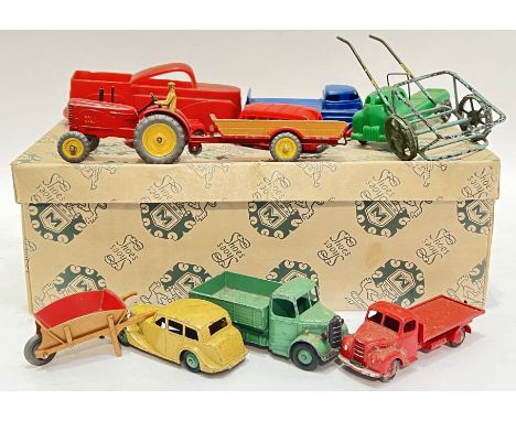 Vintage toys, a group of Dinky toy cars/vehicles by Meccano comprising two trucks, a yellow/ochre car, a wheel barrow, and a 