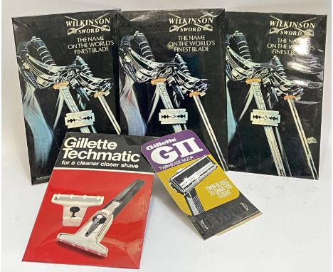 Vintage advertising, three Wilkinson Sword barber shop point of sale easel back signs (h- 43.5cm, w- 28.5cm), a Gillette ease