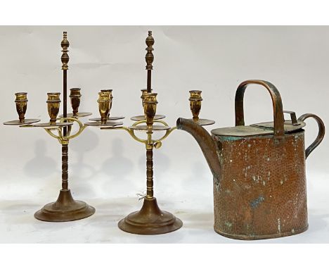 A pair of brass and copper four-arm candlestick holders (h- 40cm, w- 24cm), together with a beaten/planished copper watering 