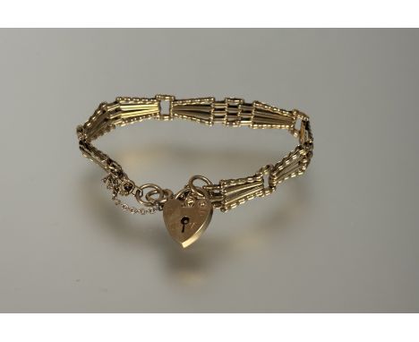 A 9ct gold gate link bracelet with heart shaped padlock and safety chain no signs of hard solder or repairs D x 8cm 11.03g&nb
