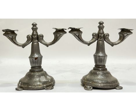 An unusual pair of planished pewter candlestick holders with Chinese-inspired design of bracketed lotus to stem, raised on ru