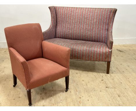 An Edwardian mahogany club chair in coral upholstery and an Edwardian wing back sofa with sweeping arms (sofa: h. 94cm x l. 1