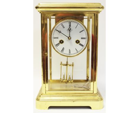 A 20th century brass mantel clock by Rapport, London, unsigned movement striking on a bell, the signed white dial with Roman 