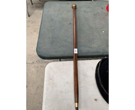 A WOODEN FOUR FACED BUDDAH HANDLED WALKING STICK 