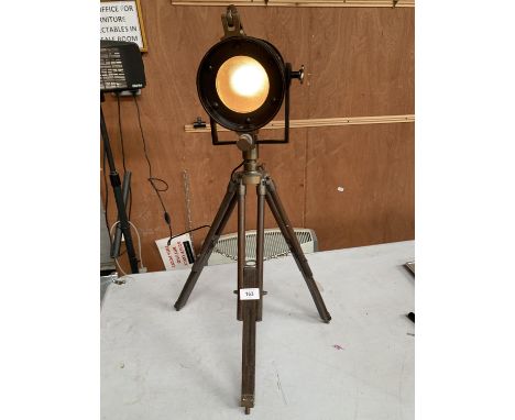 A STAGE LIGHT ON A WOODEN TRIPOD IN WORKING ORDER 