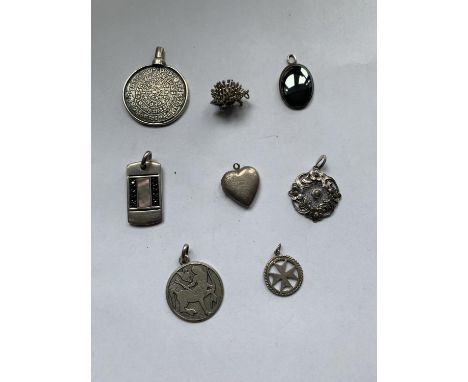 EIGHT MARKED SILVER PENDANTS TO INCLUDE A HEDGEHOG, HEART LOCKET, MALTESE CROSS ETC 