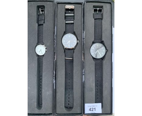 THREE NEW AND BOXED FASHION WATCHES WITH BLACK CANVAS STRAPS - ENGRAVED ON THE BACK -  EAGLEMOSS COLLECTIONS 1970'S AUSTRALIA