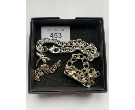 THREE STAMPED SILVER BRACELETS TO INCLUDE A CURB LINK AND A DRAGON FLY EXAMPLE 