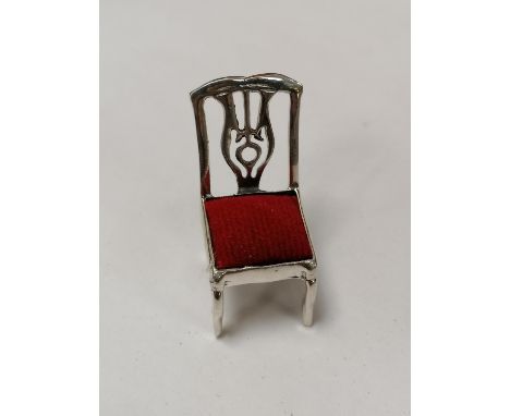 A MINIATURE .925 SILVER CHAIR PIN CUSHION 