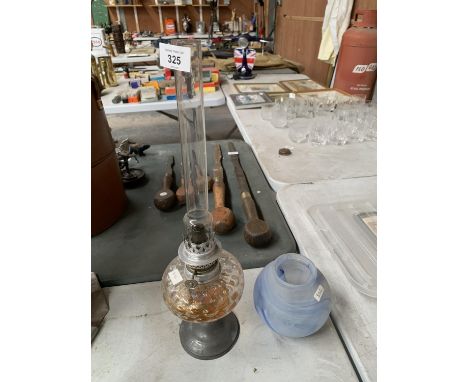 A OIL LAMP WITH PEWTER AND GLASS BASE AND A FROSTED BLUE GLASS SHADE 