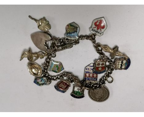 A LADIES STAMPED SILVER CHARM BRACELET WITH SIXTEEN STAMPED SILVER CHARMS 