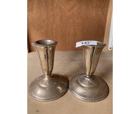 A PAIR OF SILVER CANDLES STICKS (ONE REPAIRED) 11CM HIGH 