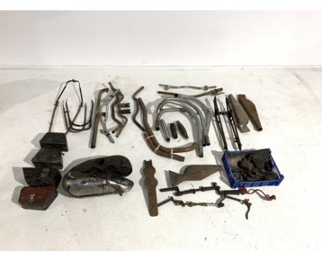 A selection of Vintage or Veteran partsincluding a Raleigh petrol tank; four toolboxes; fork blades; exhaust components; hand