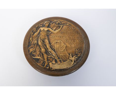 George Tucker - A 1921 Brooklands BMCRC Bronze Roundelmounted on wooden plaque, 22cm diameter with British Motor Cycle Racing