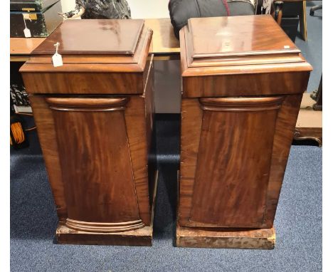 A pair of Victorian mahogany single door dining room pedestal cupboards of architectural form with caddy tops and simple plin