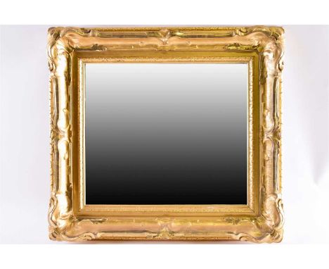 A 20th-century rectangular wall mirror with carved swept and gilt frame. 68 cm high x 75 cm longCondition report: Good clean 