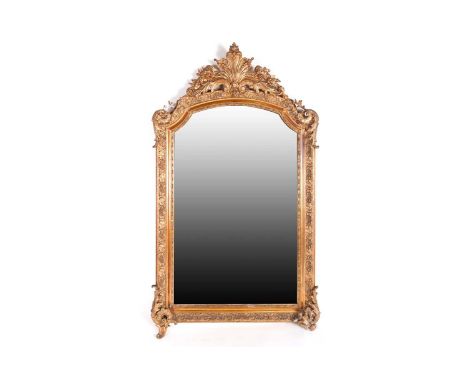 A late 19th-century rococo form carved wood and gilt gesso arch-topped rectangular wall mirror, with scroll and floral cresti