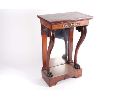 A 19th century Empire style figured mahogany console table with gilt metal mounts, bold cabriole lions paw monopodia with ebo