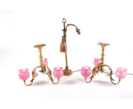 A pair of gilt brass ceiling lamps, with three scroll arms and opaline pink shades, 37 cm high, together with a gilt brass ta