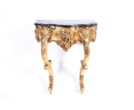 An Italian giltwood console table with marble top, early 20th century, the shaped marble top above a frieze of carved and pie