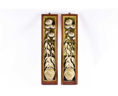 A pair of 20th century five-tile panels, relief-decorated in the aesthetic taste, mounted in wooden frames, 83 cm high.Qty: 2