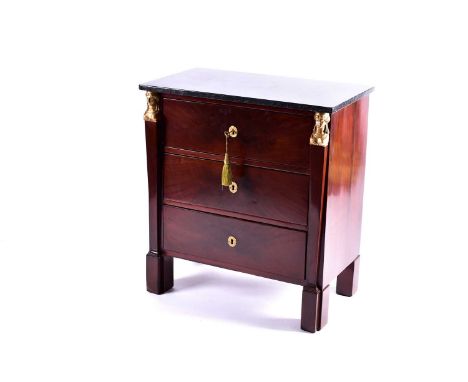 A French Empire style marble-topped mahogany commode, late 19th/early 20th century. Fitted three drawers flanked by a pair of