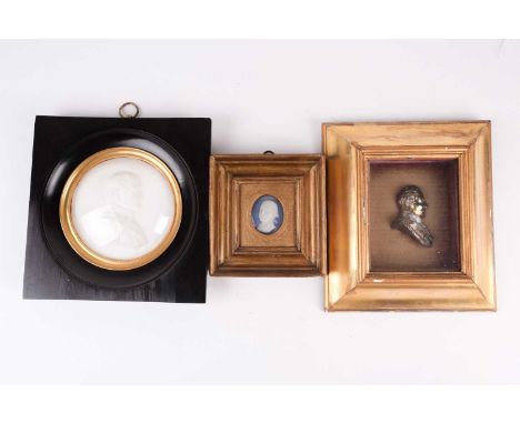 A 19th century plaster high-relief bust of Napoleon Bonaparte in profile, housed in an ebonised frame, 11 cm diameter, togeth