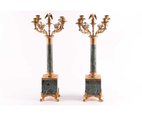 A pair of large 19th century French Empire style ormolu and green marble candelabra, each with four branches surrounding an e