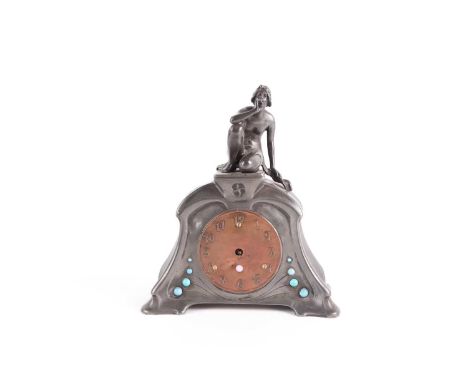 A pewter Art Nouveau mantel clock, of naturalistic triangular form, with figural surmount, copper dial and inset with turquoi