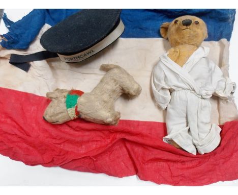 Vintage teddy bear, small dog, Sea Cadet cap and French flag.