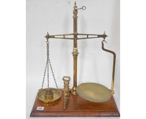 Brass W & T Avery balance beam scales, with 7 bell and 6 stacking weights, upon rectangular mahogany stand, height 20".