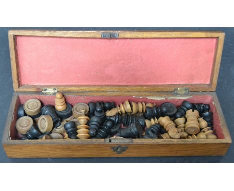 A turned box wood and ebony part chess set (1 box wood piece missing) together with a 14 piece draughts set, within a "Gants"