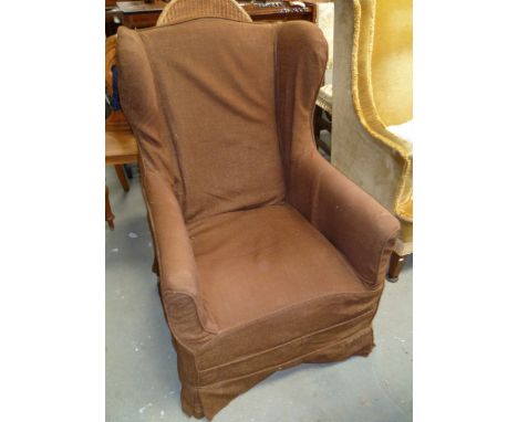 George III mahogany wing back armchair with square tapering legs terminating in brass caps and ceramic casters.