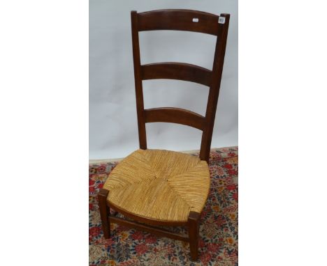 Arts and Crafts yew rush seated low ladder-back chair on square tapered legs united by stretchers.