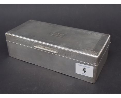 Silver rectangular cigarette box, with engine turned decoration and monogram, width 7.5", London 1928.