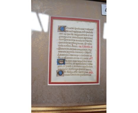 A late medieval illuminated vellum manuscript page, in Latin, embellishments in red, blue and gilt, 4.25" x 3.25", framed tog
