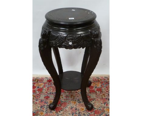 20th Century Chinese hardwood circular stand in Chinese taste, with Greek key carved top over a carved apron and four scroll 